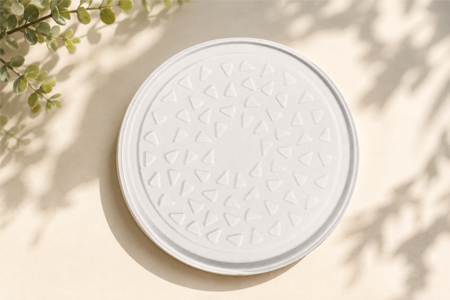 Compostable bagasse plates stacked for commercial foodservice use
