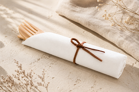 Bamboo cutlery set beside disposable food packaging