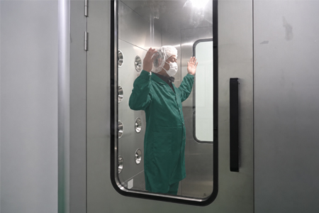 Factory employee passing through an air shower before entering the controlled food packaging production area